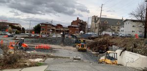 Photo of the Laurel Forest housing project being underway with excavators and tractors at work inside a gravel lot building foundation.