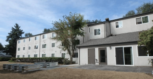 A multi-family property, its many windows facing the camera