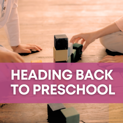 A warm-toned photo of kids playing with blocks is overlaid with a magenta banner with white text that says "Heading back to preschool."