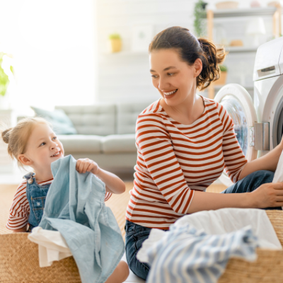 A mother and daughter do their laundry together.