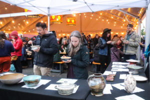 People choose from a variety of handmade bowls from local artists.
