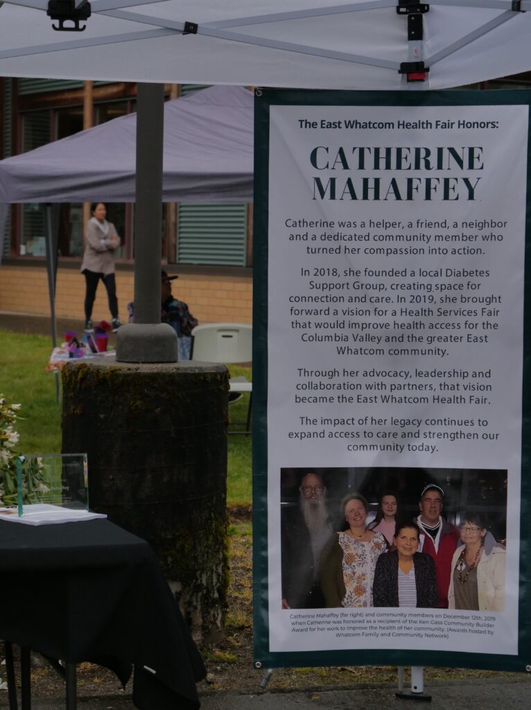 Vertical poster set up under a canopy that says "Catherine Mahaffey" with a blurb under it